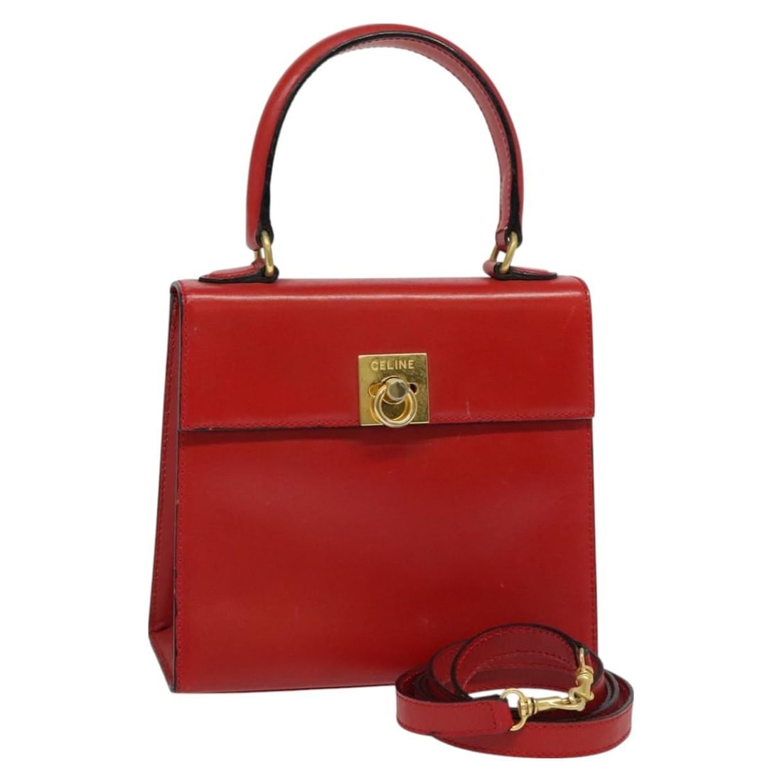 Red Leather Vintage Logo Top Handle Bag by Celine: Red Leather Vintage Logo Top Handle Bag by Celine This Celine Vintage Logo Top Handle Bag is crafted from red leather and features a structured silhouette with a top handle and shoulder strap. Designe