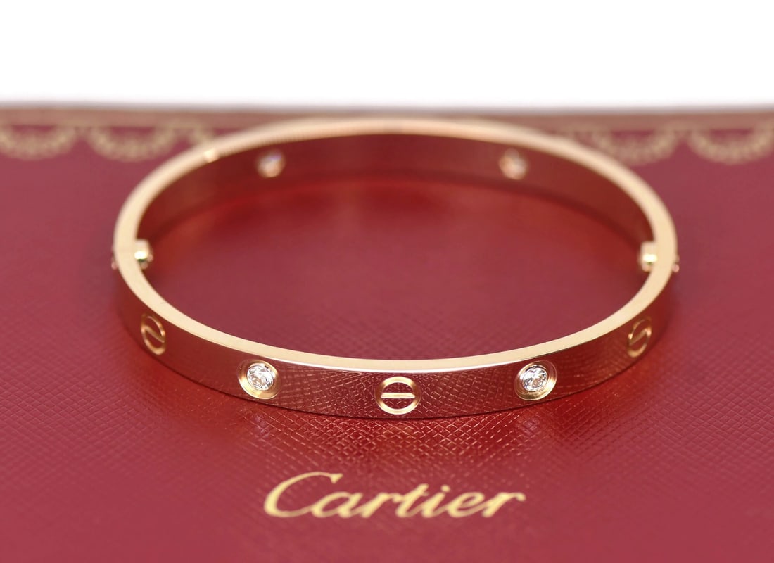 Cartier Love Bangle 18K Rose Gold with 4 Diamonds Size 16 with Box and Certificate: Cartier Love Bangle 18K Rose Gold with 4 Diamonds Size 16 with Box and Certificate This Cartier Love bangle bracelet is crafted from 18K rose gold and features four diamonds. The bracelet is in pre-ow