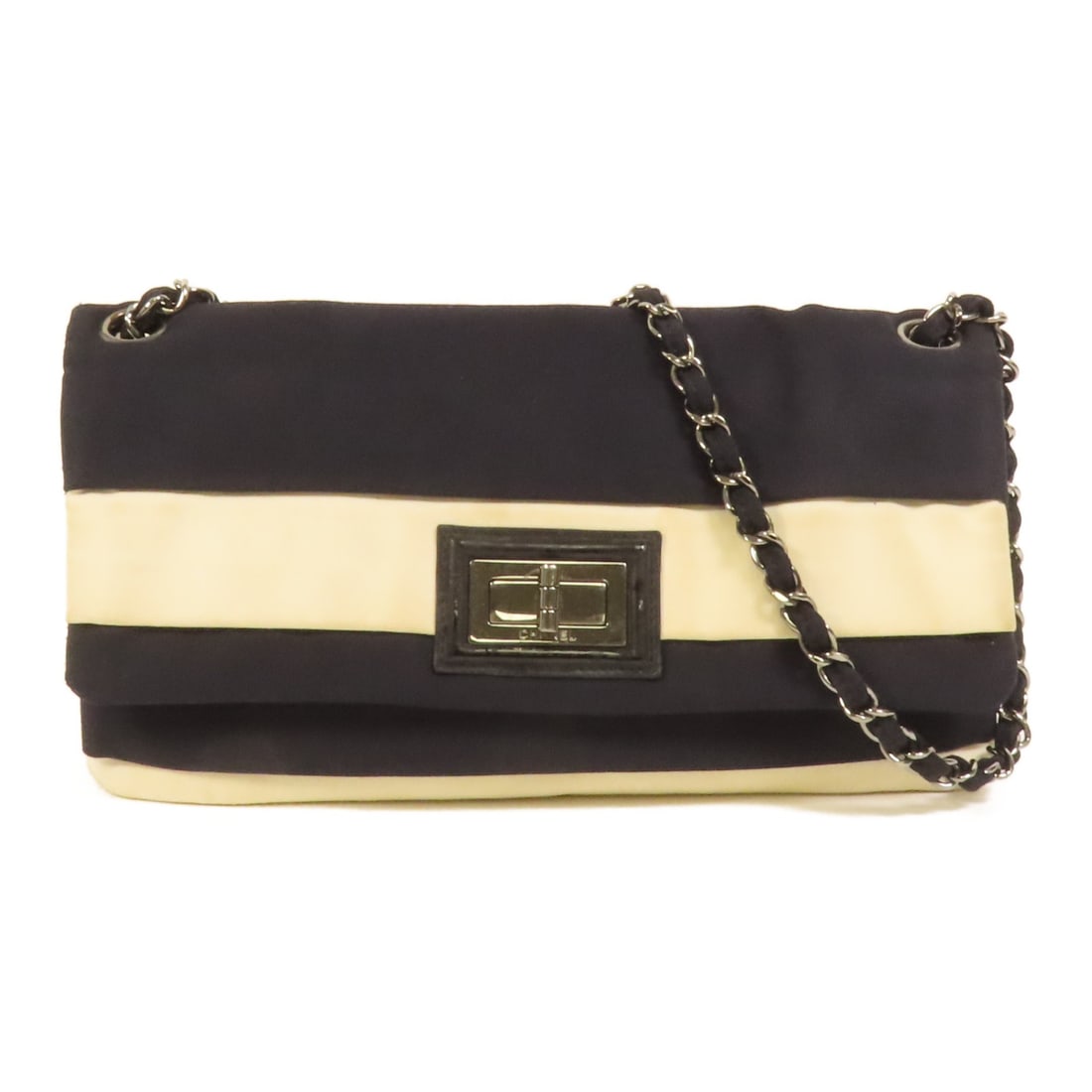 Chanel Canvas Black and White Shoulder Bag with CC Silver Hardware: Chanel Canvas Black and White Shoulder Bag with CC Silver Hardware This CHANEL shoulder bag features a classic black and white design crafted from canvas. Made in France, the bag showcases the iconic