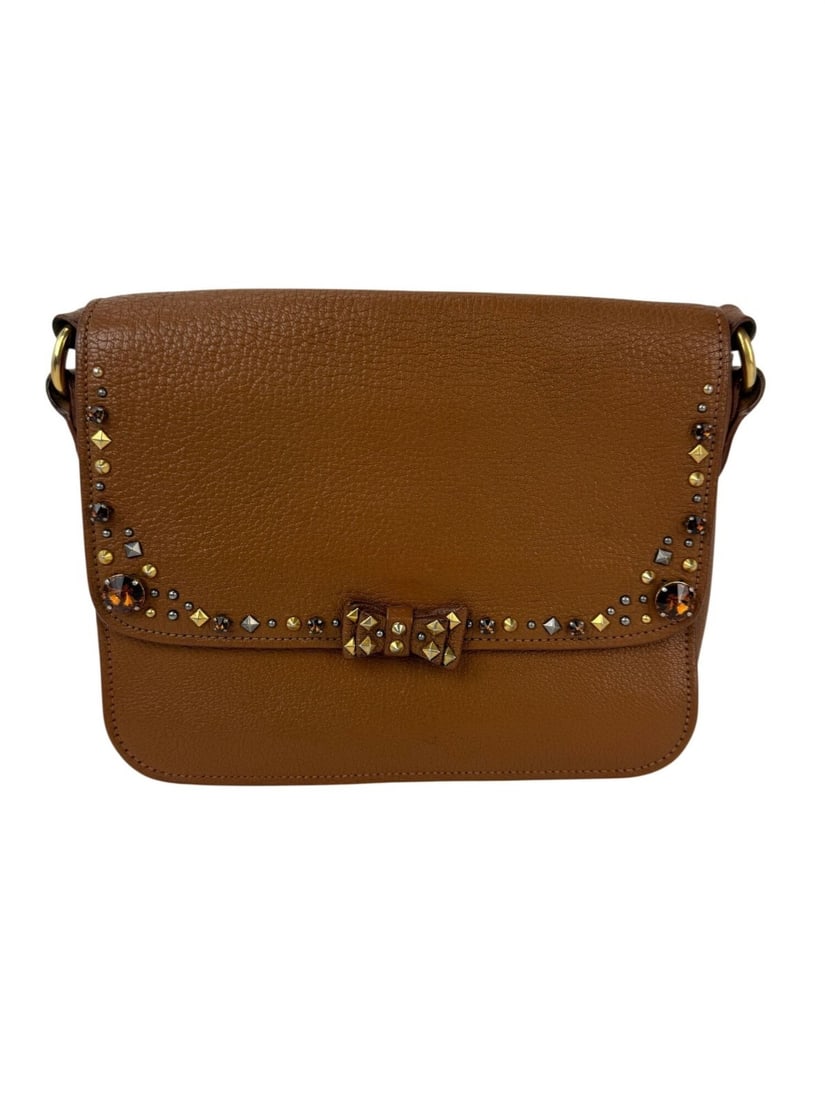 Miu Miu Madres Brown Leather Crossbody with Crystals: Miu Miu Madres Brown Leather Crossbody with Crystals This Miu Miu Madres crossbody bag exudes elegance with its rich brown leather exterior and crystal accents. Designed for casual parties or cocktail