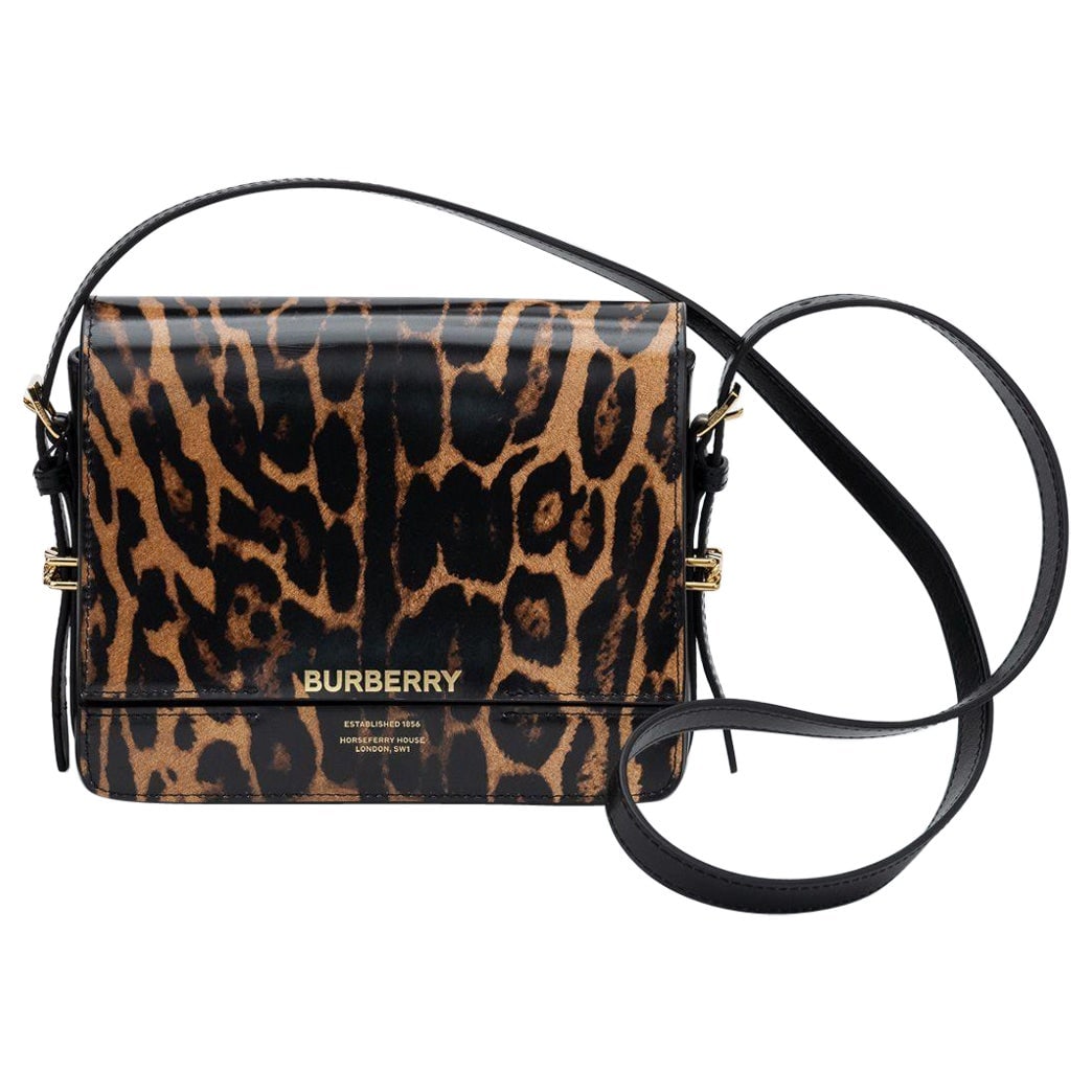 Burberry New Calfskin Black Cheetah Print Shoulder Bag: Burberry New Calfskin Black Cheetah Print Shoulder Bag This stunning Burberry shoulder bag is crafted from premium calfskin leather, featuring a striking black and cheetah print design. The bag is bot