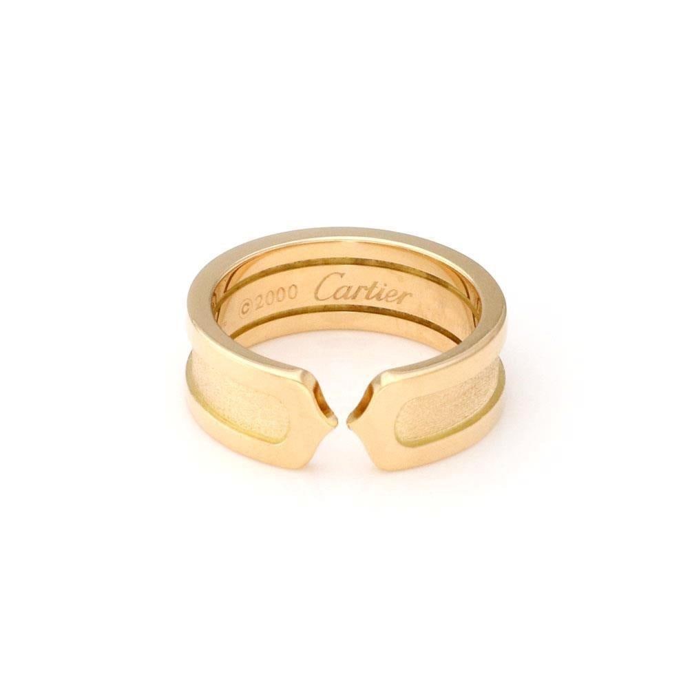 Cartier Double C Ring 18k Yellow Gold Cuff Band Size 48 US 5: Cartier Double C Ring 18k Yellow Gold Cuff Band Size 48 US 5 This authentic Cartier Double C cuff band ring is expertly crafted from 18k yellow gold, showcasing a stunning brushed and high-polished fi
