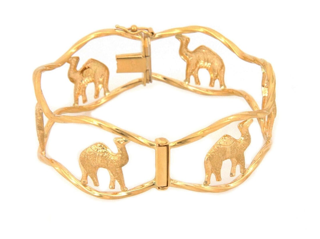 18k Yellow Gold Wide Wave Openwork Cuff Bangle Bracelet with Camel Motif: 18k Yellow Gold Wide Wave Openwork Cuff Bangle Bracelet with Camel Motif This statement cuff bangle bracelet is expertly crafted from solid 18k yellow gold and features a wide, open wave design with a