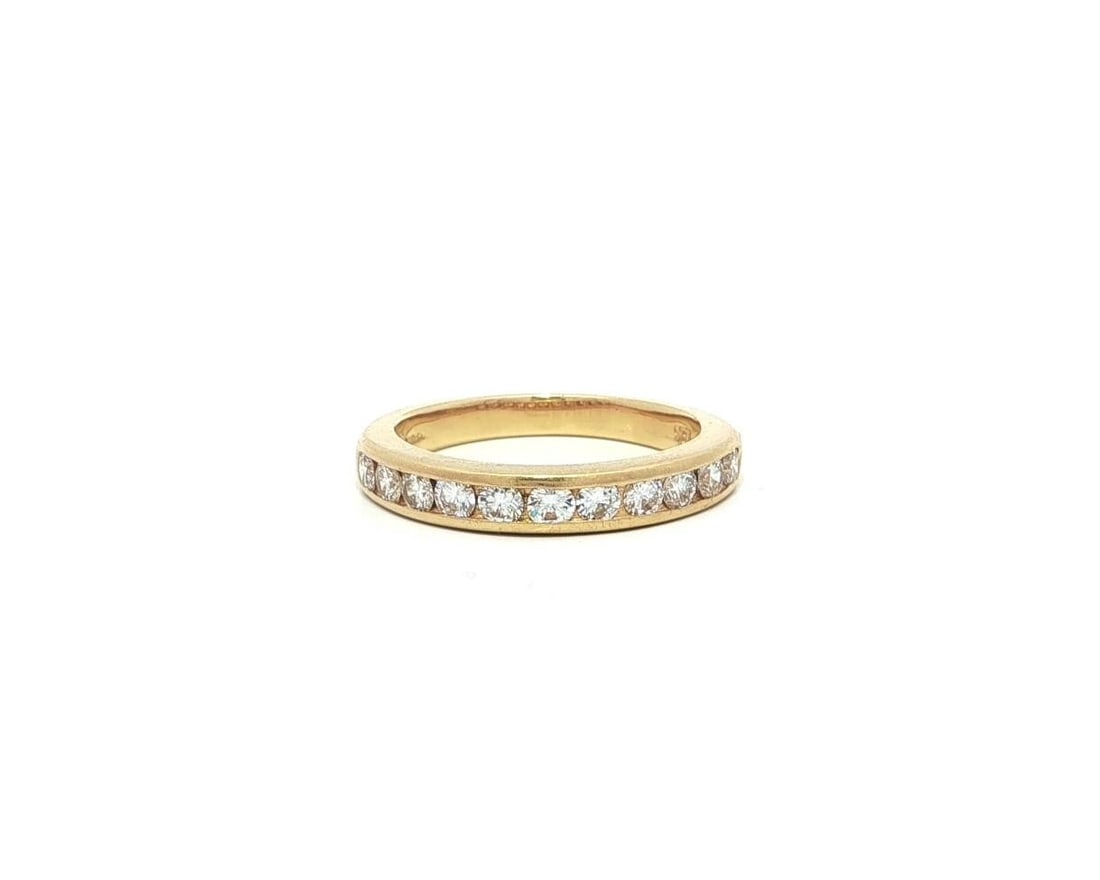 Tiffany & Co. 18k Yellow Gold Diamond Band Ring 0.35ct: Tiffany & Co. 18k Yellow Gold Diamond Band Ring 0.35ct Experience the elegance of this Tiffany & Co. band ring, crafted from solid 18k yellow gold. The ring features a stunning channel set with 11 nat