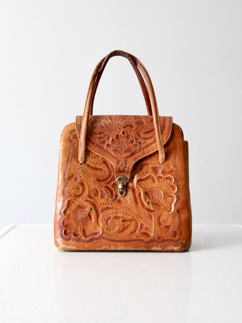 Vintage Southwestern Tooled Leather Satchel Handcrafted in Mexico: Vintage Southwestern Tooled Leather Satchel Handcrafted in Mexico This vintage southwestern tooled leather satchel showcases a rich caramel brown hue and features a classic western tooled design. The