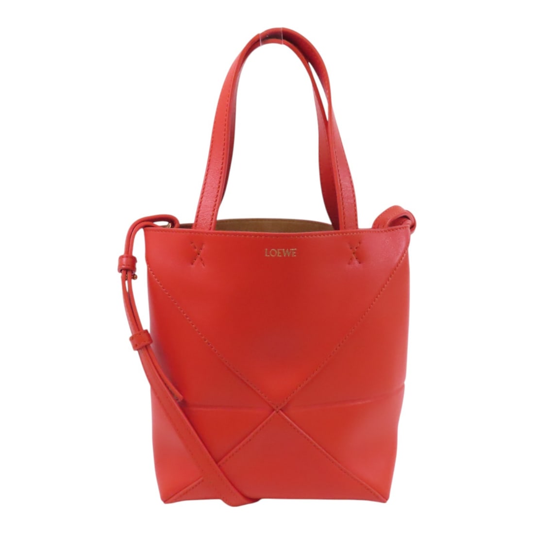 LOEWE Mini Puzzle Fold Orange Calfskin Tote with Gold Hardware: LOEWE Mini Puzzle Fold Orange Calfskin Tote with Gold Hardware This LOEWE Mini Puzzle Fold Tote Bag is a sophisticated 2-way shoulder bag crafted from premium calfskin leather in a vibrant orange hue.