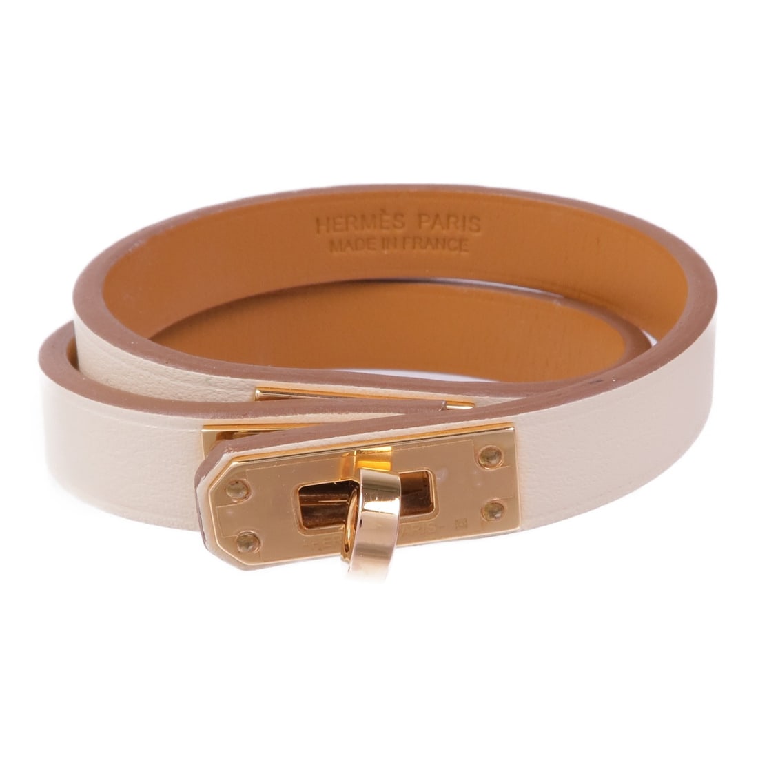 Kelly Double Tour Beige Leather Bracelet by Hermes France: Kelly Double Tour Beige Leather Bracelet by Hermes France This Hermes Kelly Double Tour bracelet features Vaux Swift calfskin leather in a beige hue, complemented by metal hardware. The design is eleg