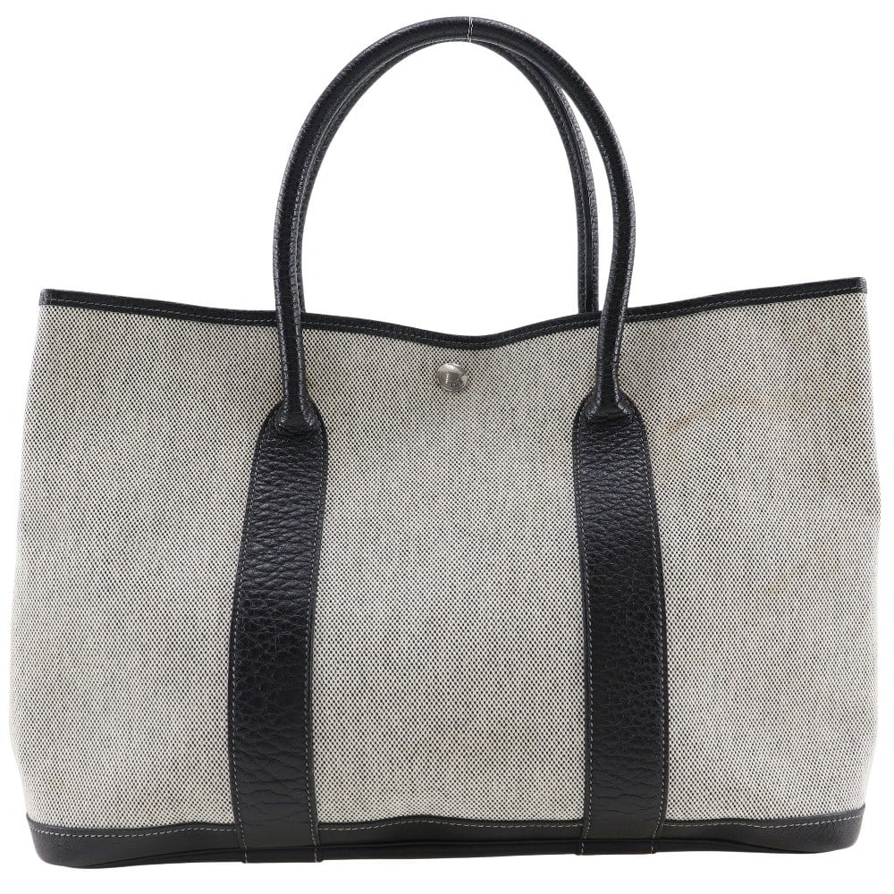 Hermes Garden Party Female Tote Gray Canvas with Leather Trim 36cm: Hermes Garden Party Female Tote Gray Canvas with Leather Trim 36cm This Hermes Garden Party Tote is crafted from gray canvas with leather accents, designed for women. It features a spacious interior a