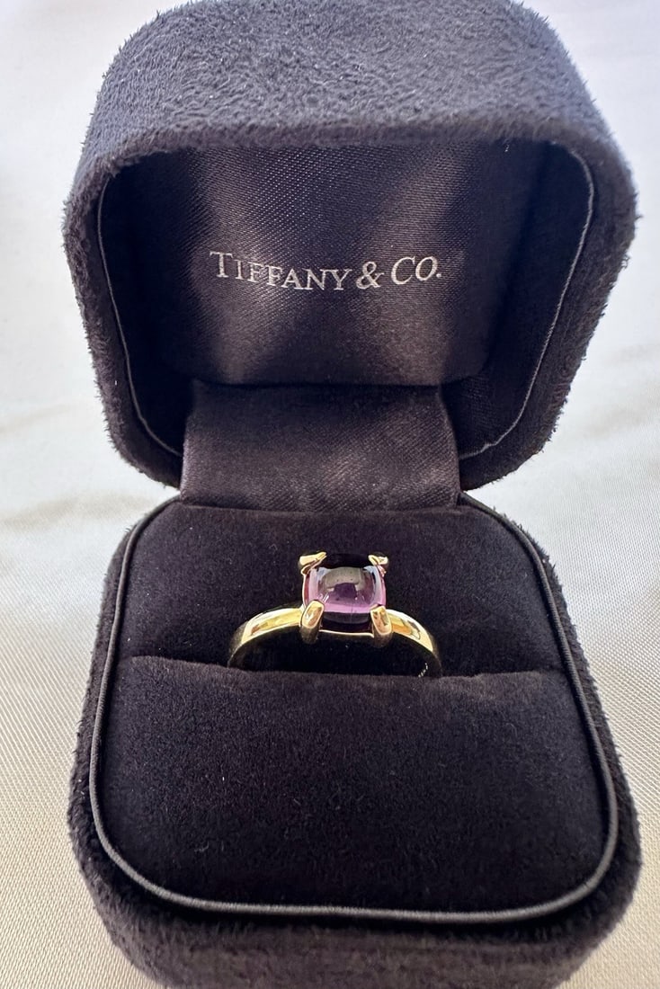 Tiffany & Co 18K Yellow Gold Amethyst Ring Size 7.5 with Original Box: Tiffany & Co 18K Yellow Gold Amethyst Ring Size 7.5 with Original Box This stunning Tiffany & Co. ring features a captivating amethyst set in lustrous 18k yellow gold. With a size of 7.5, this exquisi