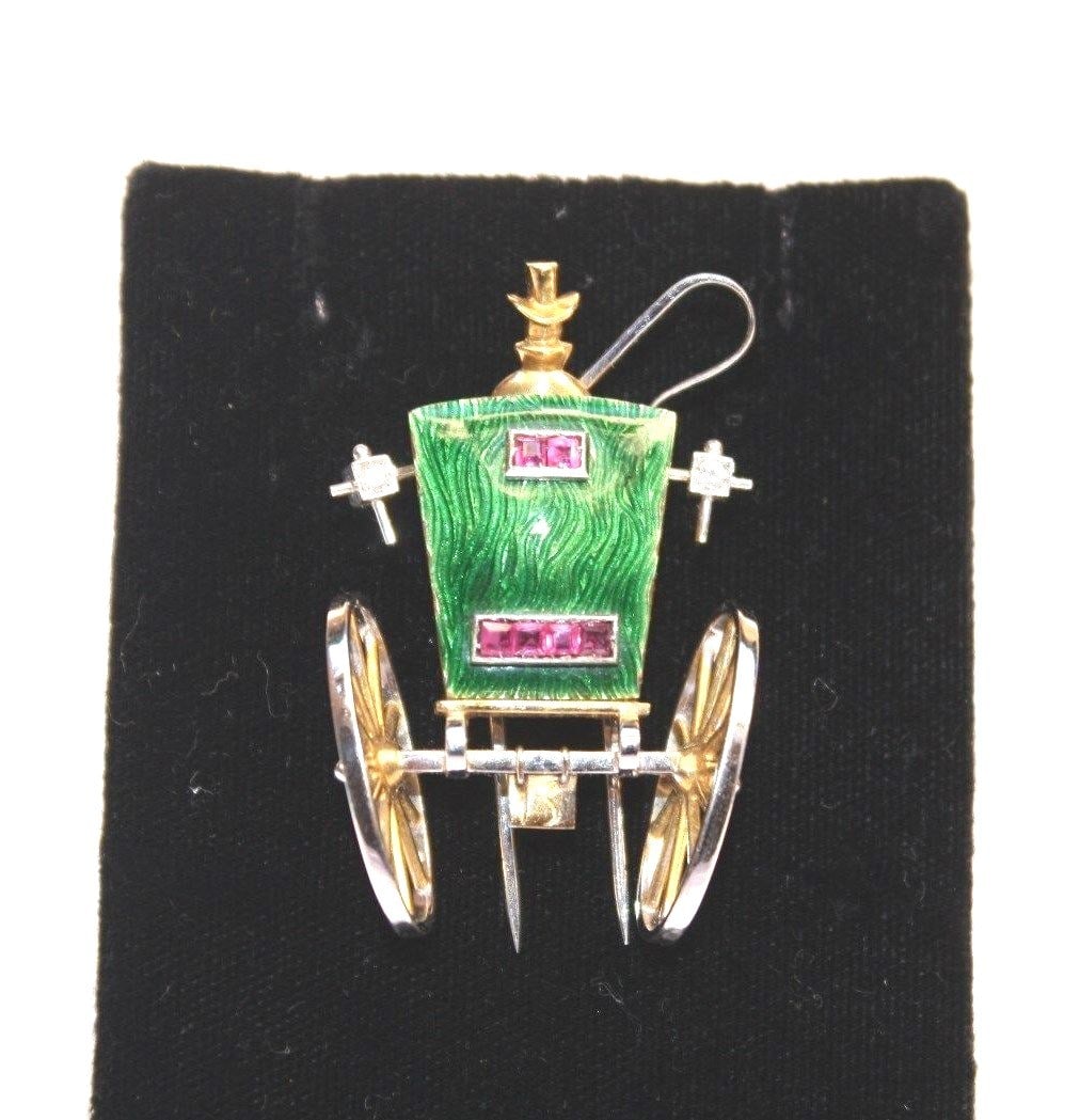 Art Deco Paul Flato 18K Gold Enamel Ruby Diamond Carriage Brooch: Art Deco Paul Flato 18K Gold Enamel Ruby Diamond Carriage Brooch This exquisite Art Deco brooch, crafted by Paul Flato, showcases the elegance of the era with its intricate design and use of luxurious