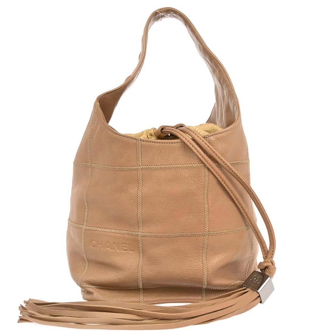 Choco Bar Wild Stitch Medium Bucket Leather Bag by Chanel: Choco Bar Wild Stitch Medium Bucket Leather Bag by Chanel This Chanel Choco Bar Wild Stitch Drawstring Handbag features light brown calfskin leather with distinctive wild stitch detailing. The medium-