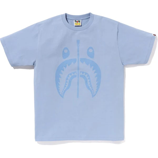 A Bathing Ape Shark Graphic Pigment-Dyed Sax Blue Cotton Tee XL: A Bathing Ape Shark Graphic Pigment-Dyed Sax Blue Cotton Tee XL The Bape Pigment Shark Sax Tee features the iconic full-zip shark face graphic printed across the front, highlighted by a pigment-dyed w