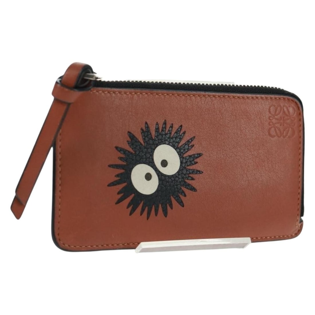 Black and Brown Leather Coin Purse by Loewe Spain: Black and Brown Leather Coin Purse by Loewe Spain This LOEWE coin purse features a sleek black and brown leather exterior and is crafted in Spain. The compact design offers practical organization for