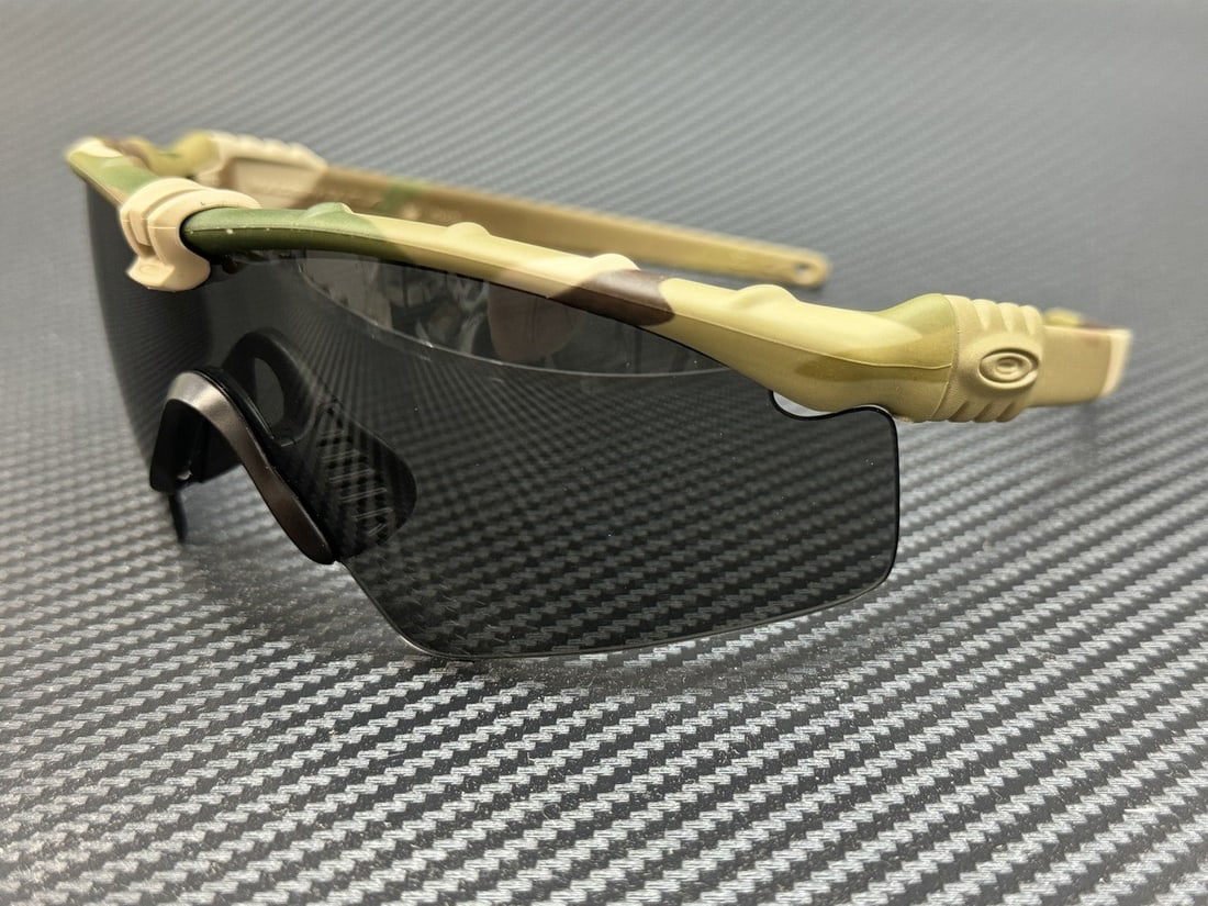 Oakley OO9146-02 Ballistic M Multicam Grey Shield Sunglasses 65mm: Oakley OO9146-02 Ballistic M Multicam Grey Shield Sunglasses 65mm These Oakley OO9146-02 Ballistic M sunglasses feature a Multicam grey plastic frame with a shield style, designed for men. The lenses