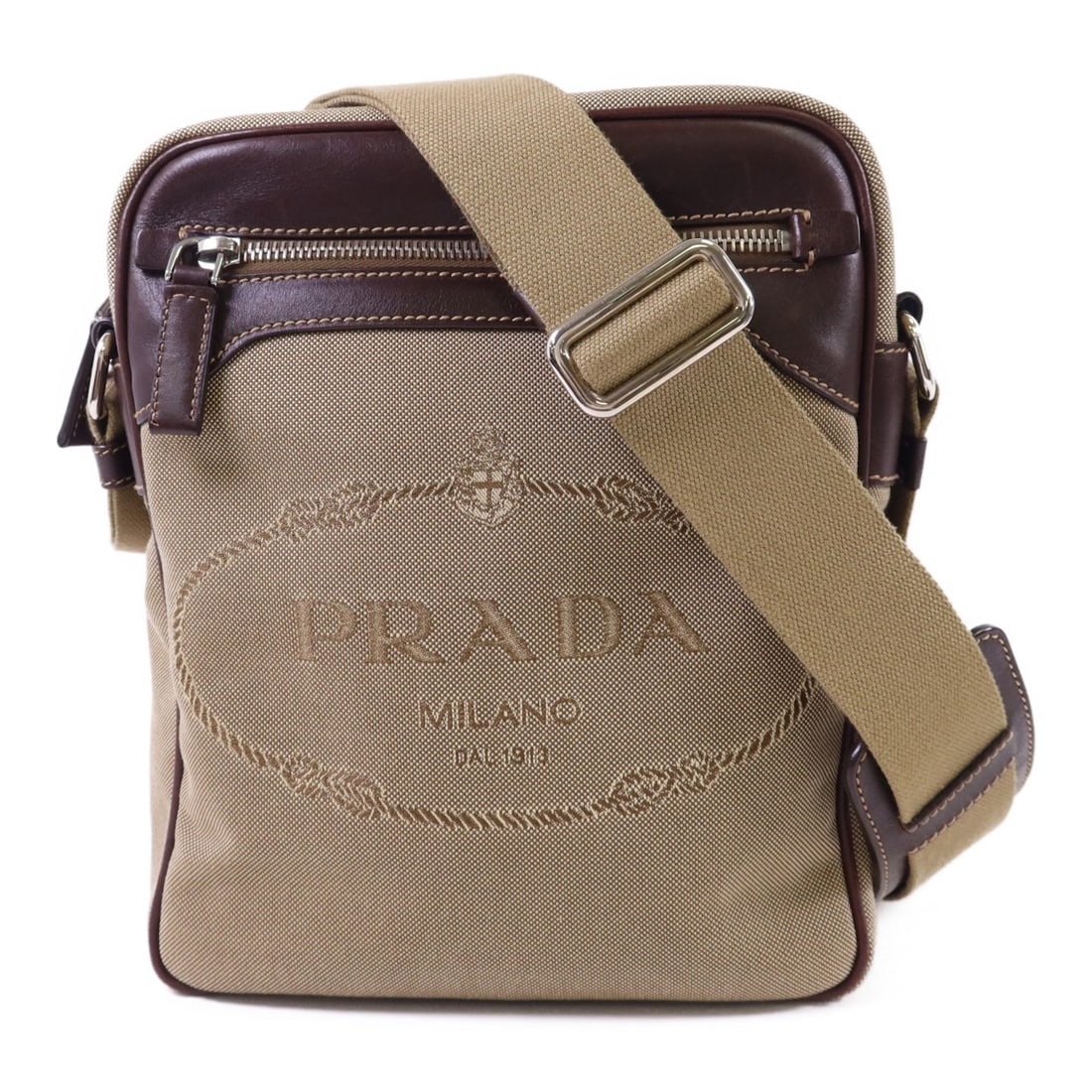 Green Canvas Prada Shoulder Bag with Silver Tone Hardware: Green Canvas Prada Shoulder Bag with Silver Tone Hardware This PRADA shoulder bag features a green canvas exterior and offers a classic, versatile design. Made in Italy, the bag provides a practical s