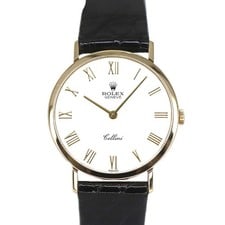 Rolex Cellini Ref 4112/8 Roman Dial Leather Papers 1995: Rolex Cellini Ref 4112/8 Roman Dial Leather Papers 1995 This Rolex Cellini features a white Roman numeral dial, a smooth bezel, and a leather bracelet. The timepiece is designated as reference number