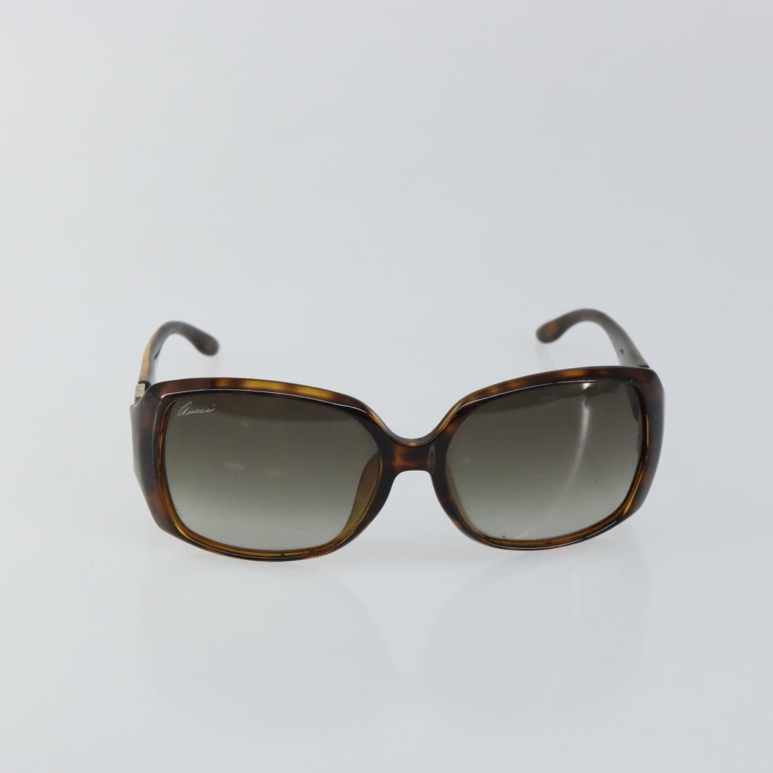 Brown Plastic Gucci Interlocking G Sunglasses for Women: Brown Plastic Gucci Interlocking G Sunglasses for Women These Gucci Eyewear sunglasses feature the iconic interlocking G detail and are designed for women. Crafted from brown plastic, they offer both