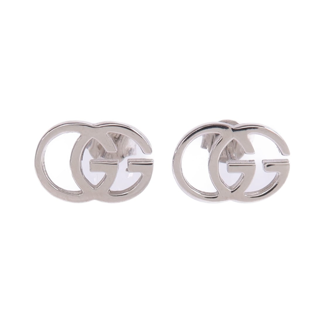 18K White Gold GG Pierced Earrings by Gucci: 18K White Gold GG Pierced Earrings by Gucci These Gucci pierced earrings are crafted from 18K white gold and feature a classic GG design. Made in Italy, they have a silver tone and do not include any