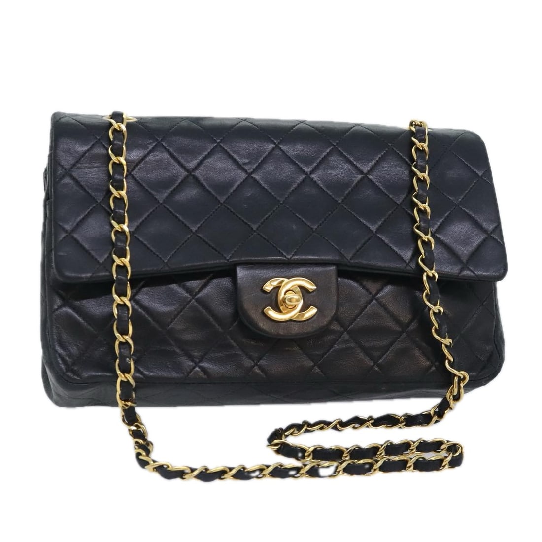 Black Lambskin Vintage Double Flap Shoulder Bag by Chanel: Black Lambskin Vintage Double Flap Shoulder Bag by Chanel This Chanel Vintage Classic Double Flap Bag features a quilted lambskin leather exterior in black and is designed for women. The bag is comple