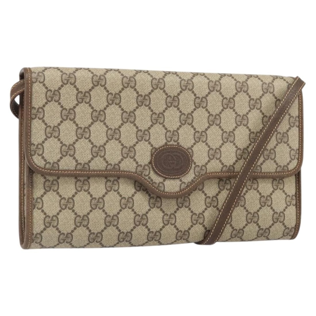 GG Supreme Beige Gold PVC Shoulder Bag by Gucci Italy: GG Supreme Beige Gold PVC Shoulder Bag by Gucci Italy This GUCCI GG Supreme shoulder bag features a beige and gold color scheme with a durable PVC leather and GG canvas exterior. The bag includes a sh