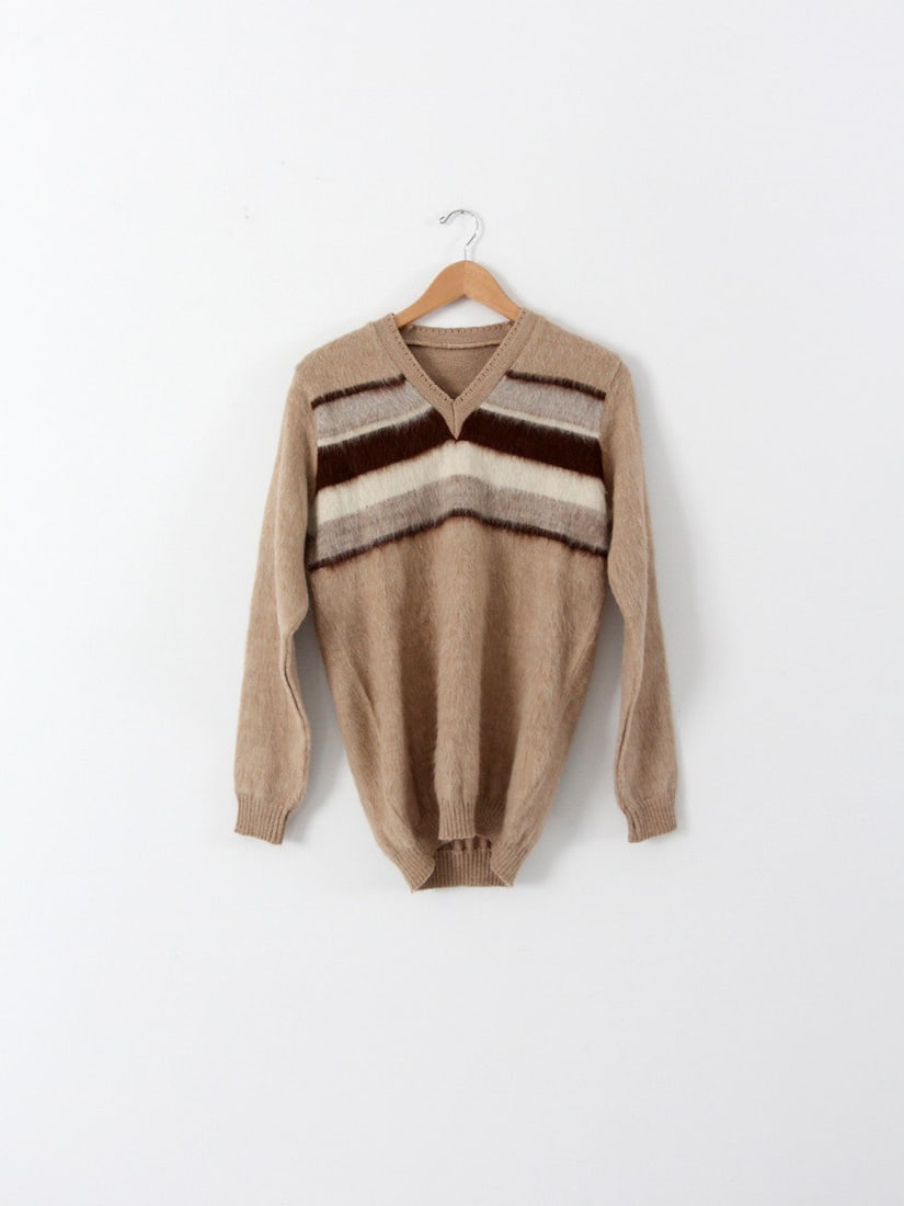 1970s Vintage Alpaca Wool Sweater Tan Striped V-Neck Pullover: 1970s Vintage Alpaca Wool Sweater Tan Striped V-Neck Pullover This vintage 1970s alpaca sweater is a stylish addition to any wardrobe. Made from soft tan wool, this pullover features eye-catching dark