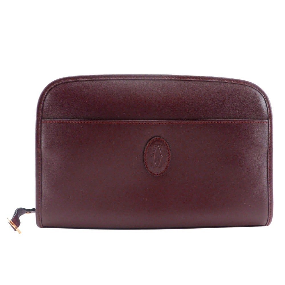 Vintage Cartier Burgundy Leather Unisex Bag 24.5cm by 16cm: Vintage Cartier Burgundy Leather Unisex Bag 24.5cm by 16cm Vintage Must de Cartier leather bag in burgundy, designed for unisex use. The exterior shows signs of wear including corner thread and wrinkl