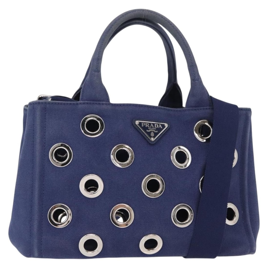 Blue Canvas Canapa Convertible Tote by Prada with Grommet Accents: Blue Canvas Canapa Convertible Tote by Prada with Grommet Accents This Prada Canapa Convertible Tote features a blue canvas exterior with grommet embellishments. Designed for women, it offers versatil