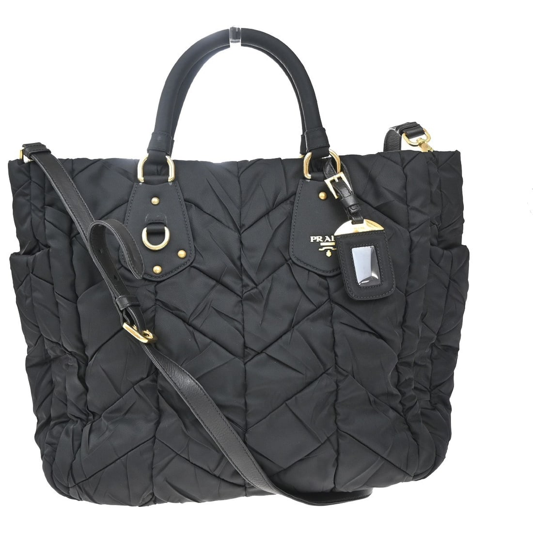 Black Nylon Prada Tote with Side Pocket and Chevron Pattern: Black Nylon Prada Tote with Side Pocket and Chevron Pattern This Prada Convertible Side Pocket Tote is crafted from black nylon and designed for women. The bag features a chevron tessuto pattern and o