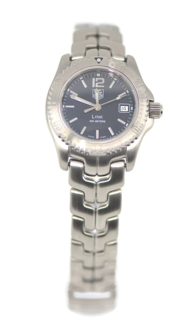 TAG Heuer Link Quartz Stainless Steel Watch WT1310 Authentic Boxed: TAG Heuer Link Quartz Stainless Steel Watch WT1310 Authentic Boxed This TAG Heuer Link wristwatch combines elegance and functionality, featuring a sleek stainless steel construction and a striking bla