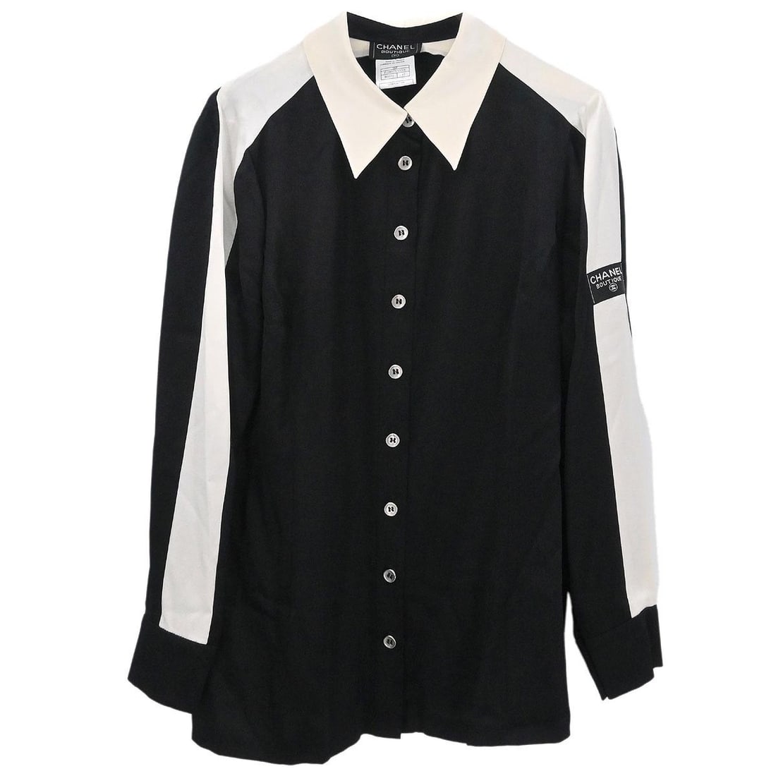 Black Silk Long Sleeve Blouse by Chanel Size 42 98P Collection: Black Silk Long Sleeve Blouse by Chanel Size 42 98P Collection This vintage Chanel blouse features a classic black design crafted from 100% silk. The long sleeves and button closure offer a timeless,