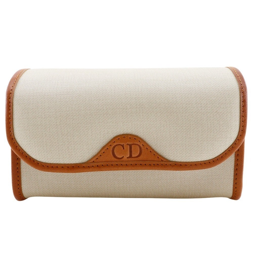 Christian Dior PVC Ecru Novelty Pouch 13cm by 8cm by 7cm: Christian Dior PVC Ecru Novelty Pouch 13cm by 8cm by 7cm This Christian Dior CD logo novelty pouch for women features an ecru-colored PVC exterior. The compact design measures 13cm x 8cm x 7cm. The po