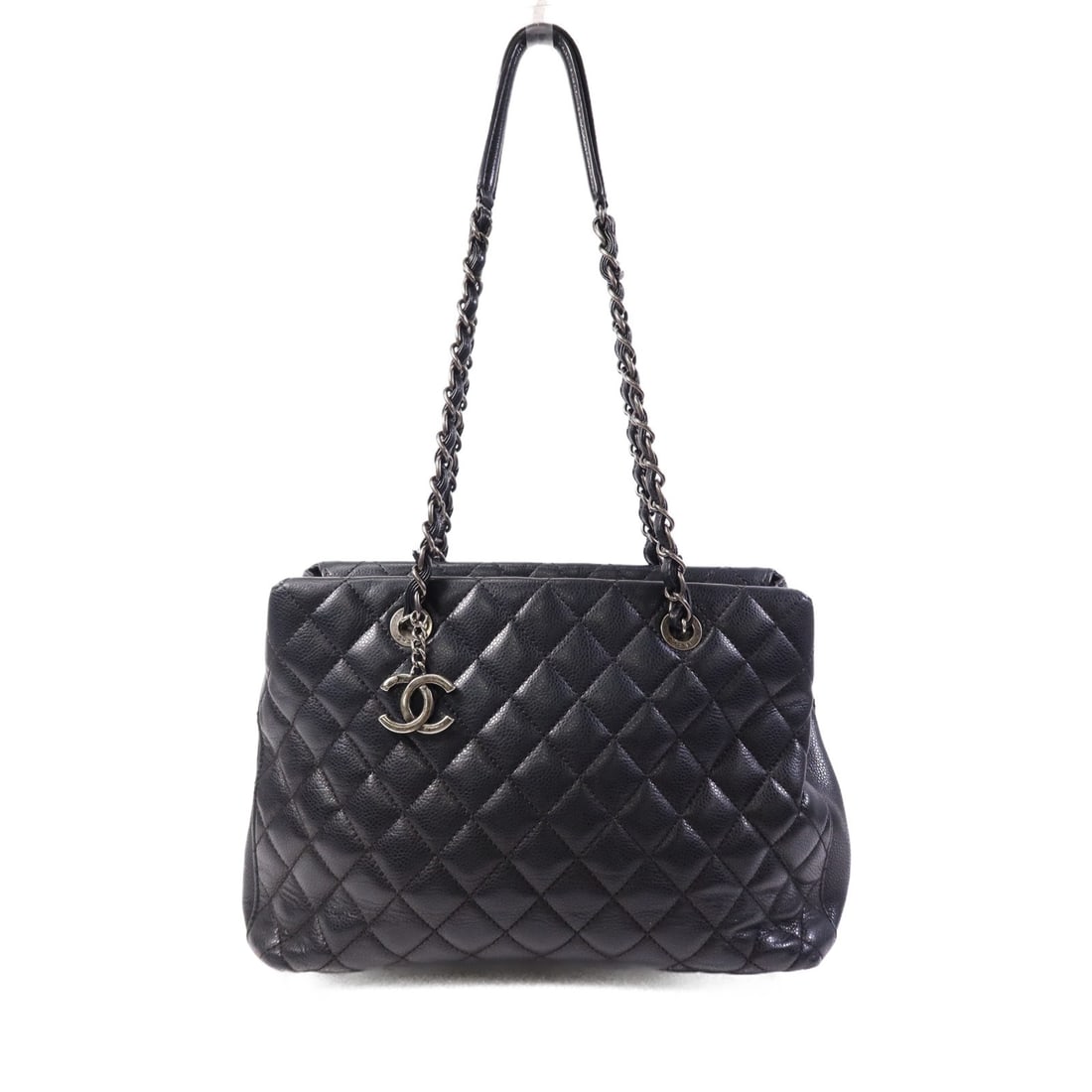 Black Calfskin Tote with CC Logo Silver Hardware by CHANEL: Black Calfskin Tote with CC Logo Silver Hardware by CHANEL This CHANEL tote bag features a black calfskin leather exterior with a structured silhouette. Crafted in France, it offers a spacious main co
