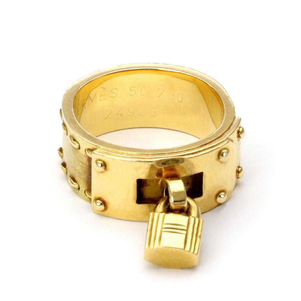 Hermes H Padlock Drop Charm Band Ring 18k Yellow Gold Size 5: Hermes H Padlock Drop Charm Band Ring 18k Yellow Gold Size 5 Discover the exquisite craftsmanship of this authentic Hermes padlock drop charm band ring, crafted from 18k yellow gold. This stunning pie