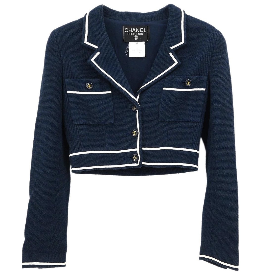 Navy Collared Cotton Jacket by Chanel Size 38 with Button Logo Accents: Navy Collared Cotton Jacket by Chanel Size 38 with Button Logo Accents This vintage Chanel single-breasted jacket features a short length and is crafted from 100% cotton in a classic navy color. Desig