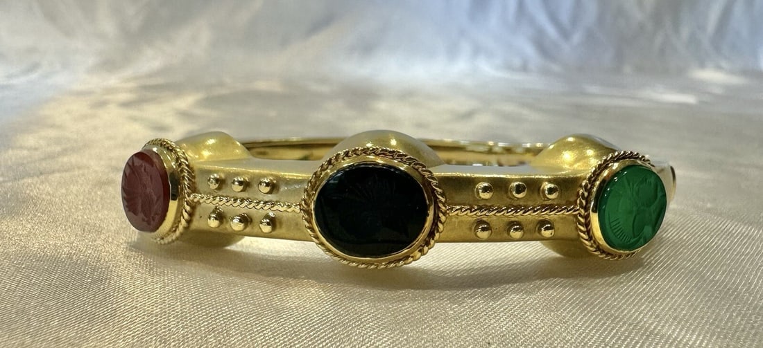 JB 18K Yellow Gold Wrap Bracelet with Carnelian Onyx Green Chalcedony: JB 18K Yellow Gold Wrap Bracelet with Carnelian Onyx Green Chalcedony This exquisite JB bracelet showcases the elegance of 18k yellow gold, enhanced by beautifully carved stones of carnelian, onyx, an