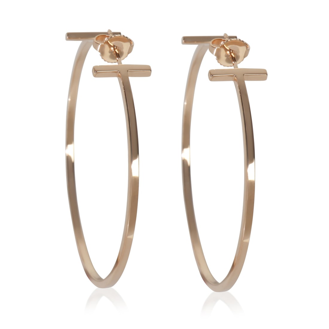 Extra Large Tiffany T Wire 18k Rose Gold Hoop Earrings 46mm: Extra Large Tiffany T Wire 18k Rose Gold Hoop Earrings 46mm These Tiffany & Co. Extra Large Tiffany T Wire Hoop Earrings are crafted from 18k rose gold, featuring a striking hoop design in a pink hue.