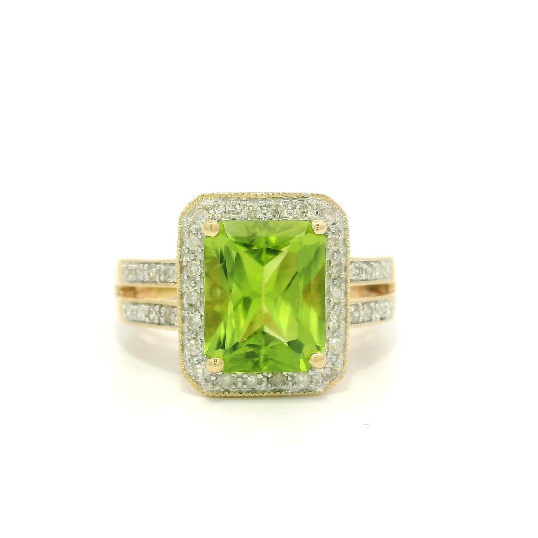 14k Yellow Gold 3.20ctw Peridot Diamond Cocktail Ring: 14k Yellow Gold 3.20ctw Peridot Diamond Cocktail Ring This stunning cocktail ring features a vibrant natural peridot, elegantly set in solid 14k yellow gold. The rectangular cut peridot measures appro