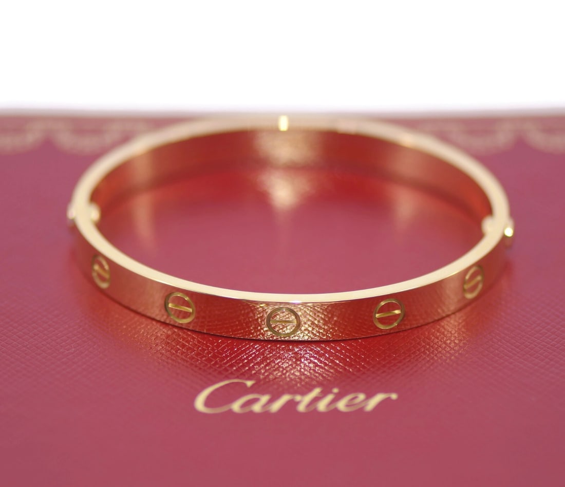 Cartier 18K Yellow Gold Love Bangle Bracelet Size 16 Authentic: Cartier 18K Yellow Gold Love Bangle Bracelet Size 16 Authentic Introducing the exquisite Cartier 18K Yellow Gold Love Bracelet, a timeless piece that embodies elegance and romance. Crafted from high-q