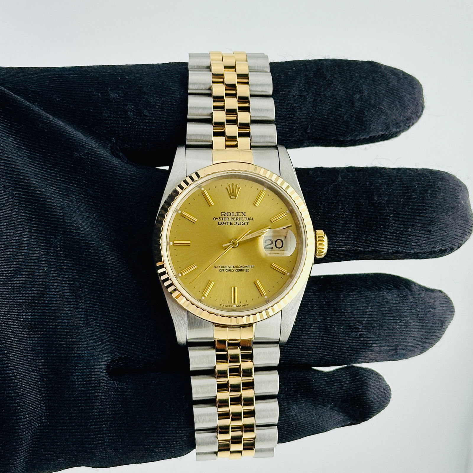 Rolex Datejust Ref 16233 Champagne Stick Dial Jubilee Bracelet Papers 1991: Rolex Datejust Ref 16233 Champagne Stick Dial Jubilee Bracelet Papers 1991 This Rolex Datejust features a champagne stick dial and is paired with a D-Link Jubilee bracelet. The timepiece has a fluted