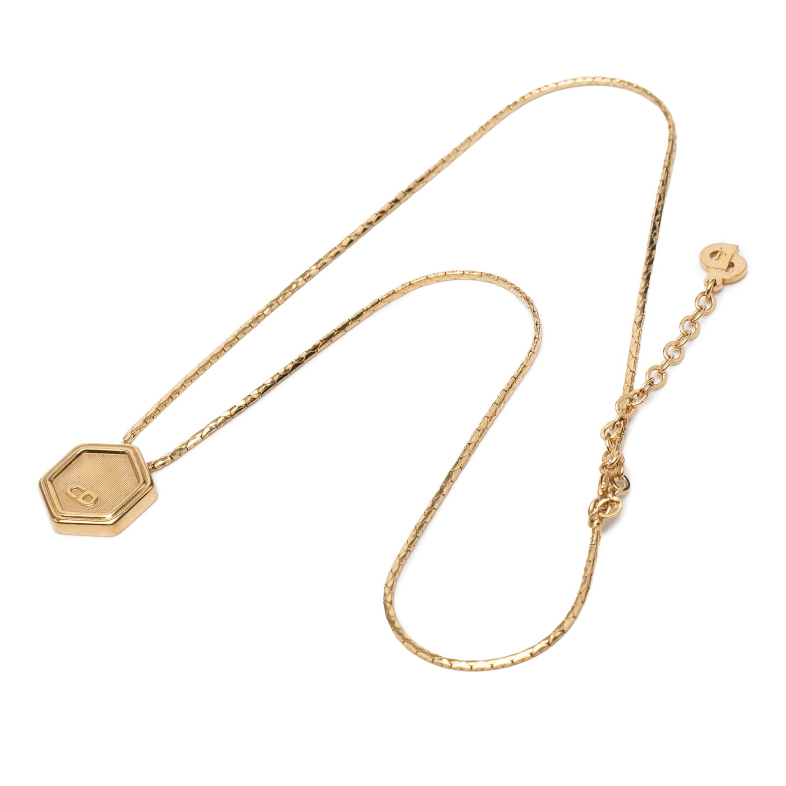 Dior Necklace with Gold Tone Hexagonal Logo Pendant: Dior Necklace with Gold Tone Hexagonal Logo Pendant This Dior necklace features a gold-tone metal body with a distinctive hexagon pendant displaying the brand's logo. It is secured with a lobster clas