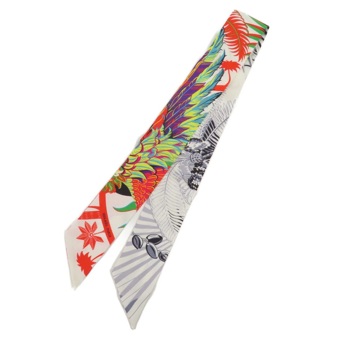 HERMES Multicolor Silk Twilly Scarf Made in France: HERMES Multicolor Silk Twilly Scarf Made in France Elevate your accessory collection with this exquisite HERMES Twilly Scarf, crafted from luxurious silk. This multicolor scarf is perfect for adding a