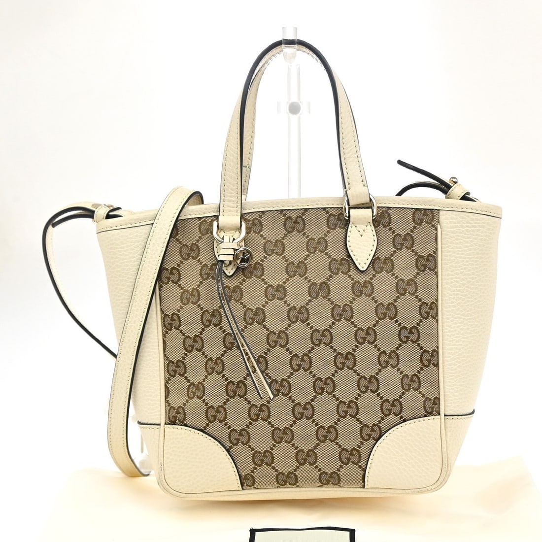 Convertible Bree Tote Bag by Gucci in Beige Canvas and Leather: Convertible Bree Tote Bag by Gucci in Beige Canvas and Leather This Gucci Bree Convertible Tote for women features a beige GG canvas exterior with leather accents. Made in Italy, it measures 20cm x 20