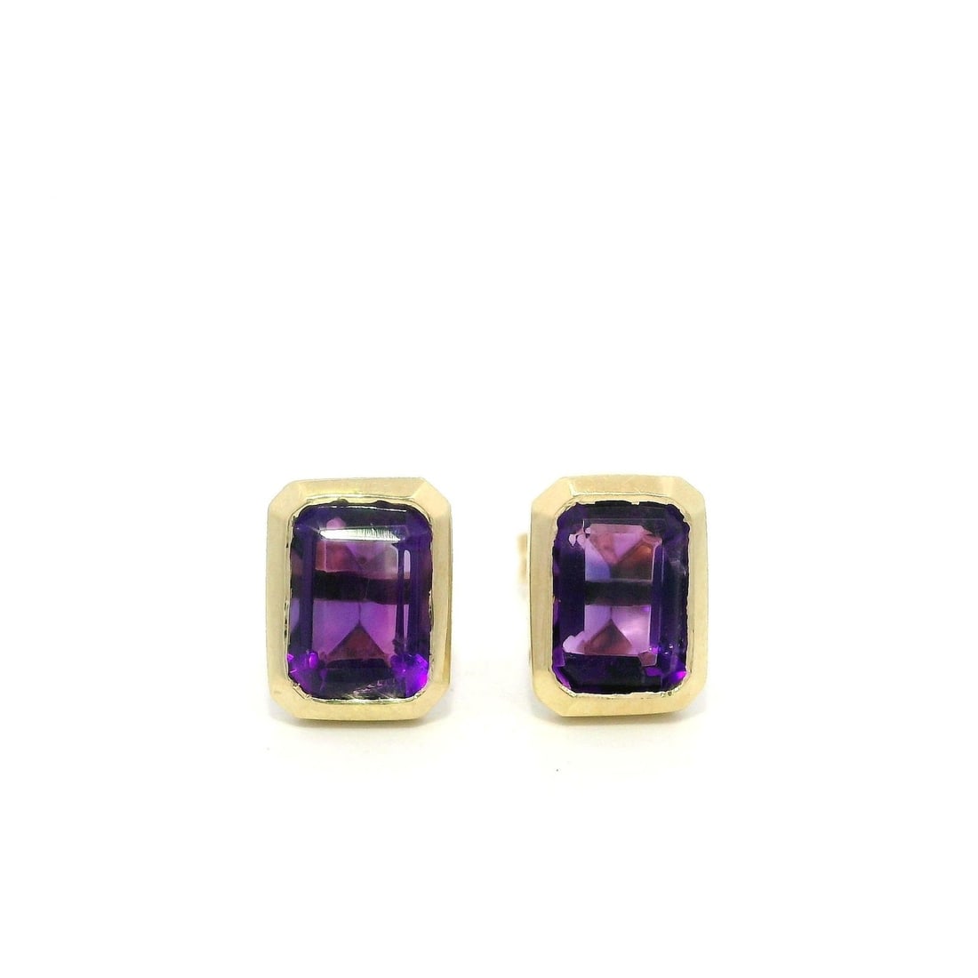 14k Yellow Gold 1.50ctw Emerald Cut Amethyst Stud Earrings: 14k Yellow Gold 1.50ctw Emerald Cut Amethyst Stud Earrings Elevate your jewelry collection with these exquisite stud earrings crafted from solid 14k yellow gold. Featuring two natural, genuine emerald