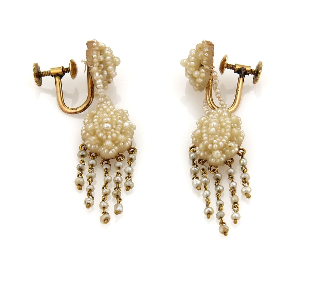 Dangle Earrings in 14k Gold with Seed Pearl Tassel Screw Back: Dangle Earrings in 14k Gold with Seed Pearl Tassel Screw Back These Pearl Tassel earrings feature a dangle/drop style with seed pearls set in 14k yellow gold. Designed with a screw back closure, they