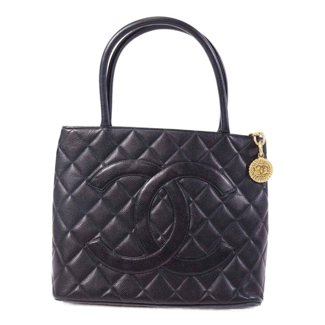 Black Calfskin CHANEL Vintage Tote Bag with CC Logo and Gold Hardware: Black Calfskin CHANEL Vintage Tote Bag with CC Logo and Gold Hardware This vintage CHANEL tote bag is crafted from black calfskin leather and features the iconic CC accent. The bag has a classic tote