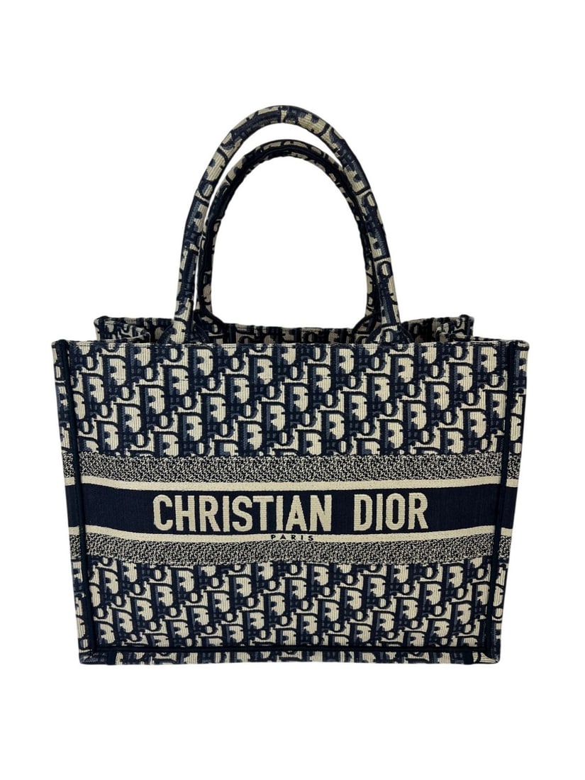 Dior Book Tote Medium Christian Oblique Blue Canvas Designer Bag: Dior Book Tote Medium Christian Oblique Blue Canvas Designer Bag This Christian Dior Medium Oblique Blue Multicolor Tote features a rectangular shape with an open top and top handles. The exterior sho