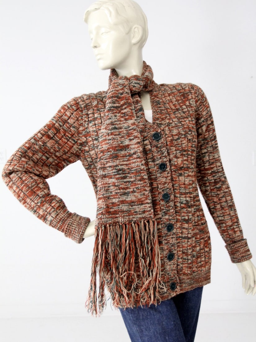 1970s Vintage Cardigan Sweater with Fringe Scarf: 1970s Vintage Cardigan Sweater with Fringe Scarf Discover a rare style find with this vintage 1970s cardigan, featuring an attached scarf. The cardigan showcases a beautiful marbled pattern in forest