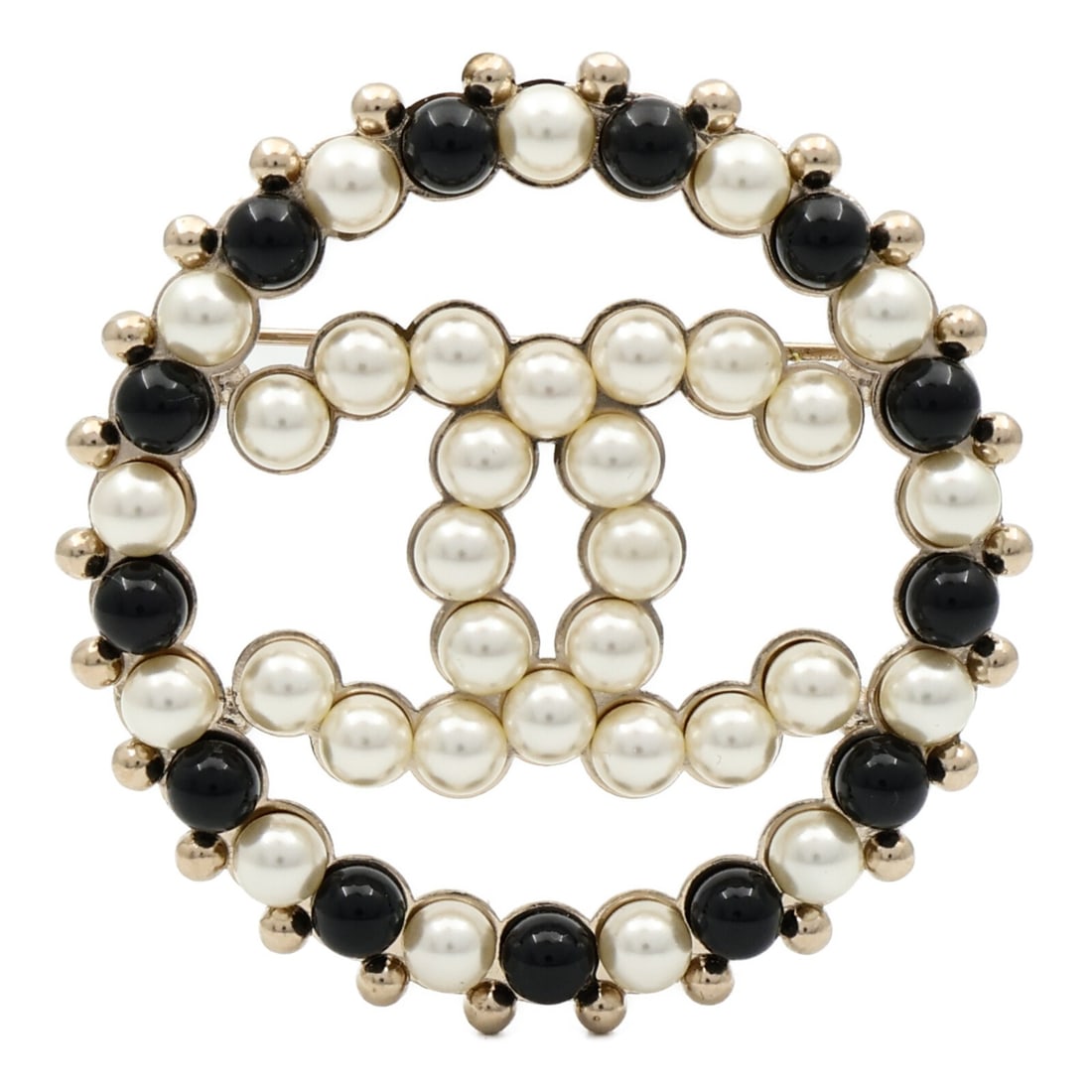 Chanel Black and White Metal CC Logo Brooch Accent: Chanel Black and White Metal CC Logo Brooch Accent This CHANEL brooch features the iconic CC logo in a striking combination of gold and black/white colors. Crafted from metal with no main stone, this