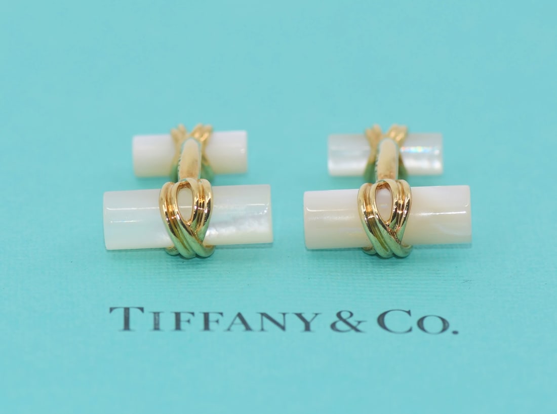 Tiffany & Co 18K Yellow Gold Bone Cufflinks with Pouch: Tiffany & Co 18K Yellow Gold Bone Cufflinks with Pouch Enhance your formal attire with these exquisite Tiffany & Co. cuff links, crafted from luxurious 18K yellow gold. These pre-owned cuff links, fea