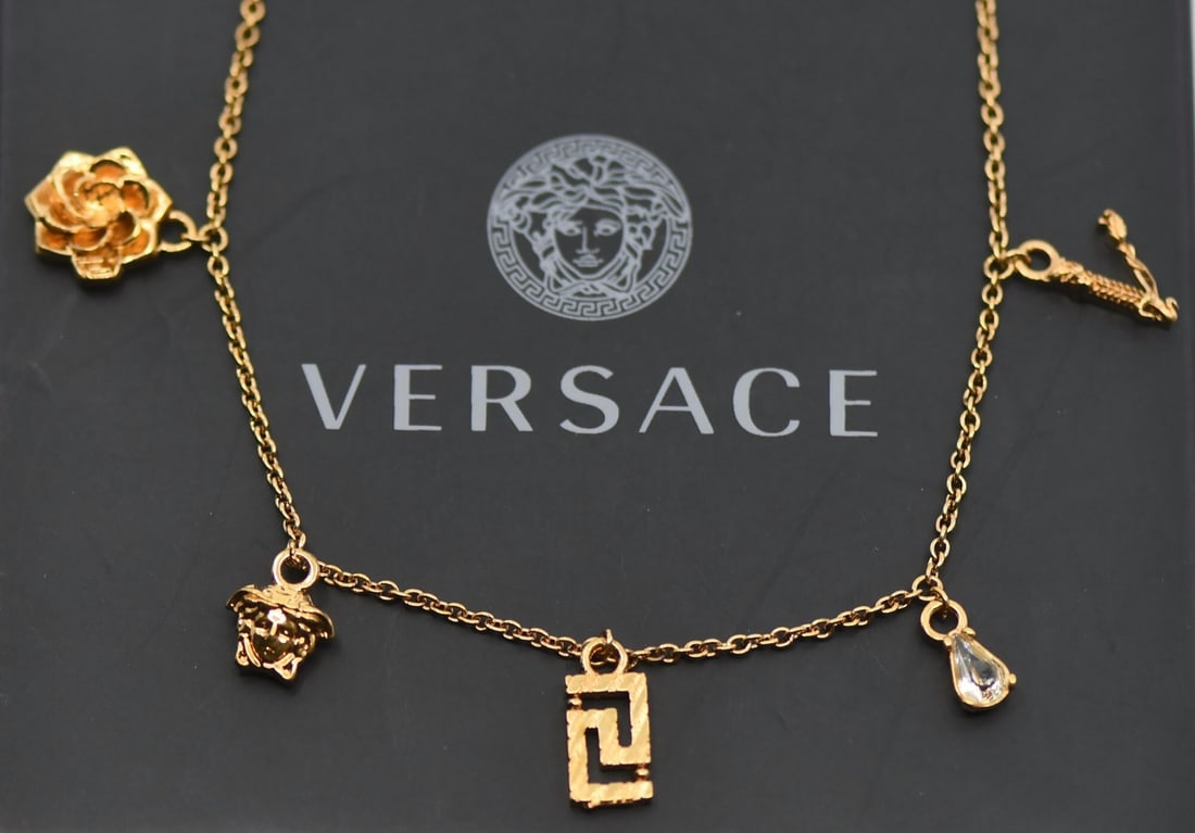 Pendant Necklace by Versace with Gold Plated Finish: Pendant Necklace by Versace with Gold Plated Finish This Versace pendant necklace features a gold plated finish and measures 16 inches in length. The necklace weighs 7.7 grams and is pre-owned. Specif